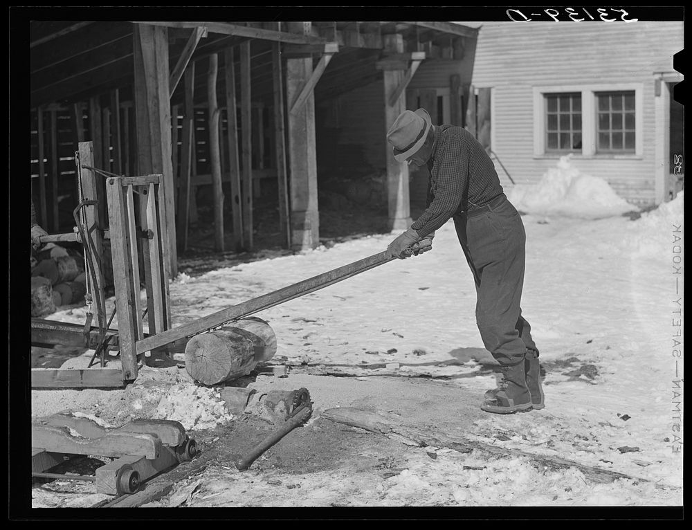 Sawing wood on farm. Woodstock, Vermont. Sourced from the Library of Congress.