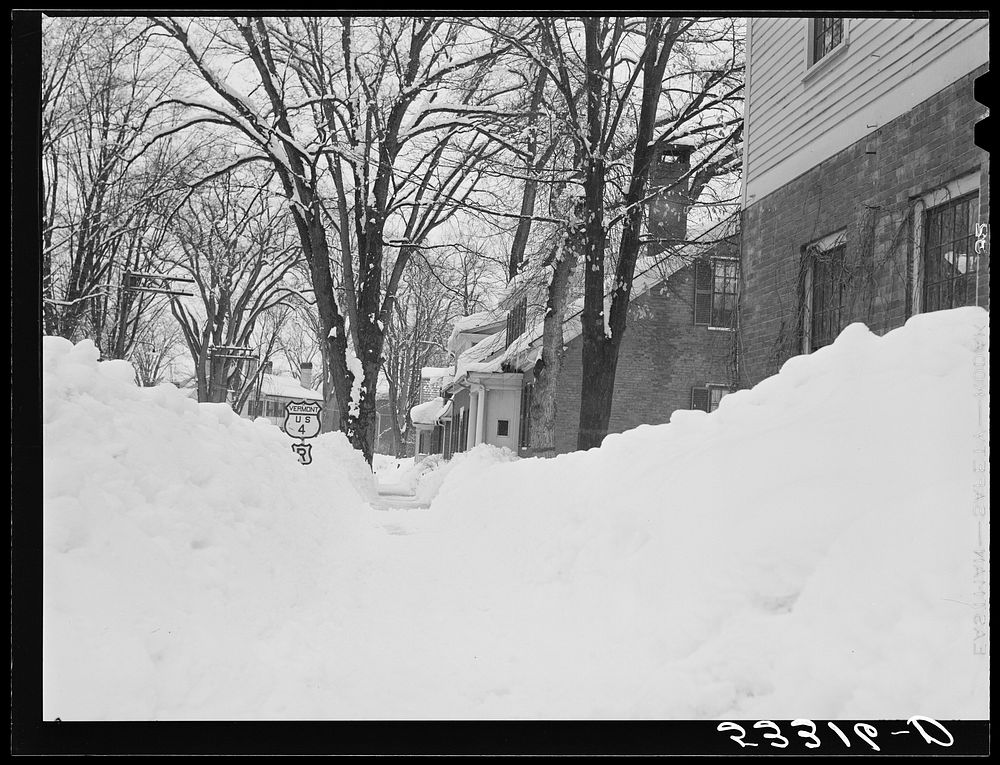 Woodstock, Vermont. Deepest snow in years piled up beside highways and sidewalks on main street. Sourced from the Library of…