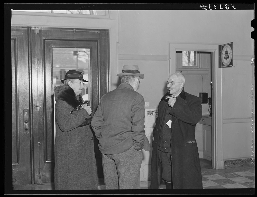 Citizens discussion town meeting in lobby of town hall. Woodstock, Vermont. Sourced from the Library of Congress.