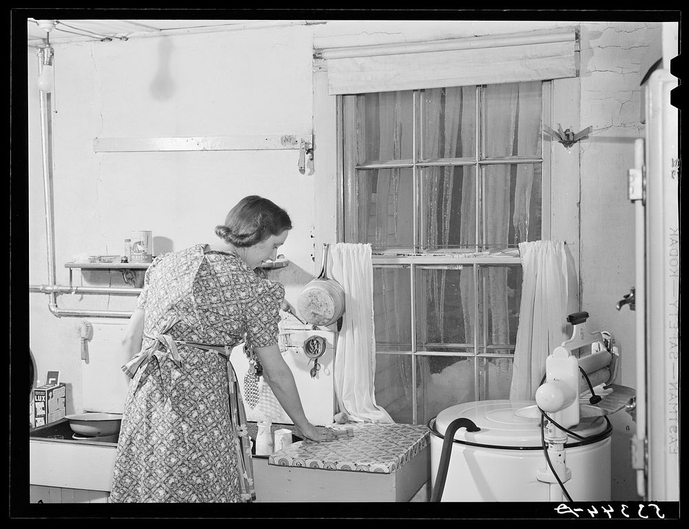 A New England housewife fixing supper on winter night. Woodstock, Vermont. Sourced from the Library of Congress.