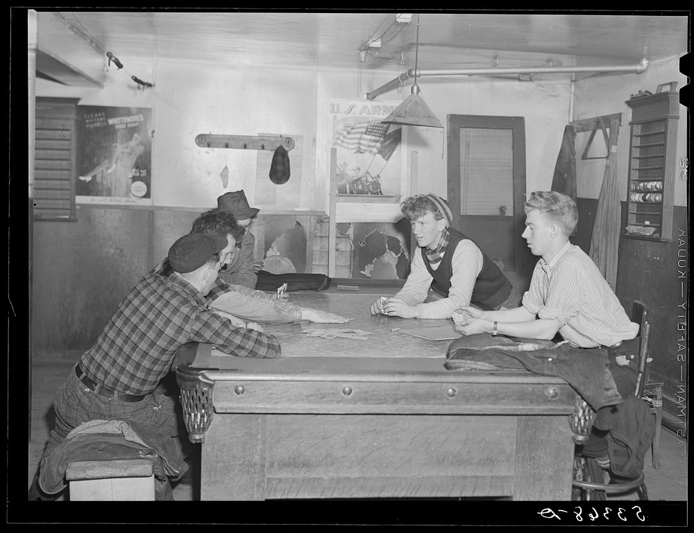 Farmers and townspeople playing cards in pool room on winter morning. Woodstock, Vermont. Sourced from the Library of…