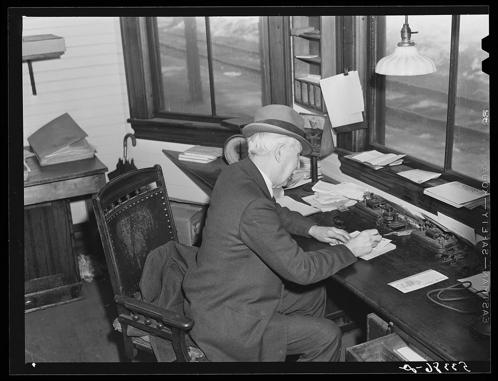 Ticket agent in railway station. Mount Whittier, New Hampshire. Sourced from the Library of Congress.