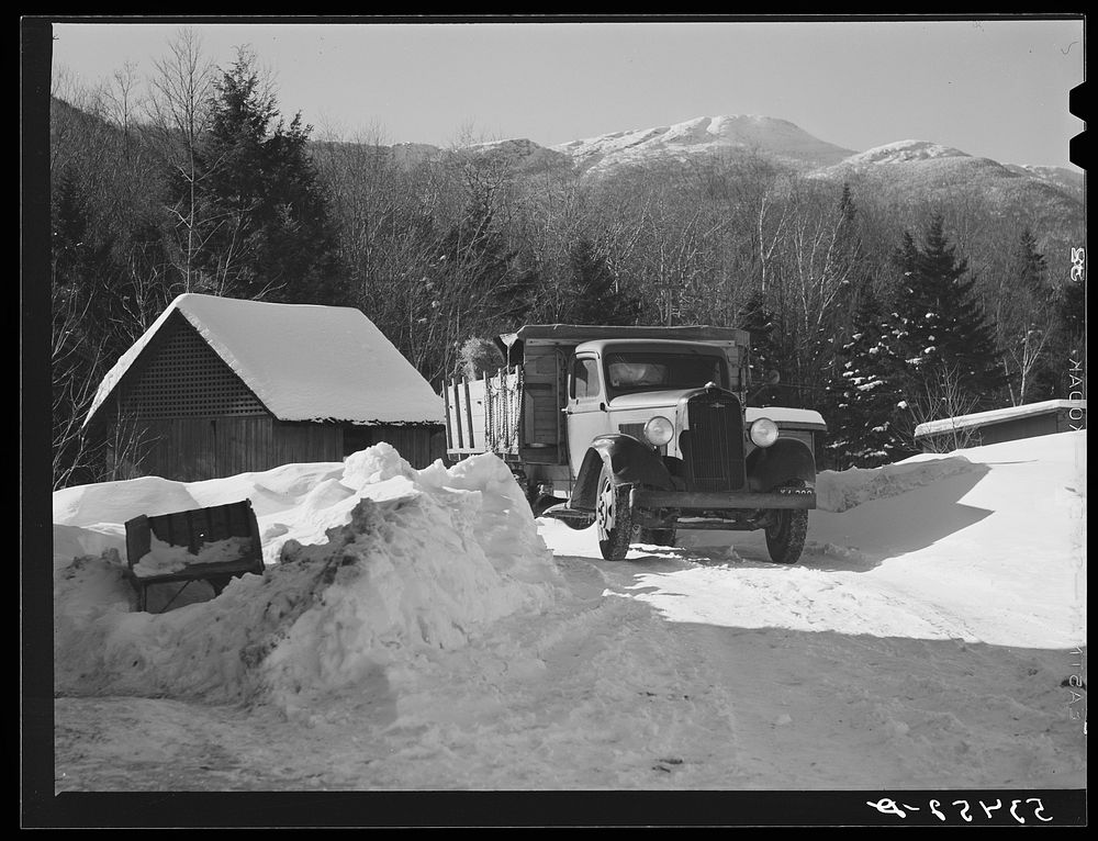 Truckload of hay being delivered at the lodge with Mount Mansfield, Smugglers Notch near Stowe, Vermont, in the distance.…