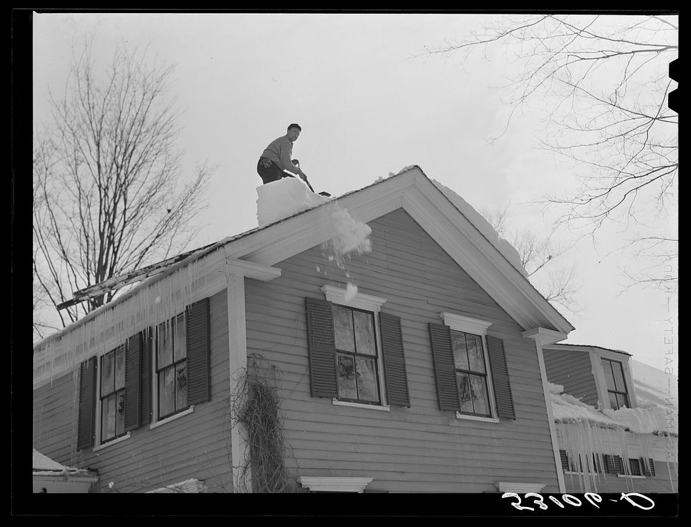 Shoveling heavy snow off roof of house in Woodstock, Vermont. Sourced from the Library of Congress.