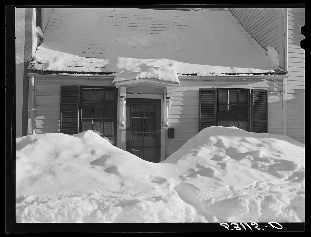 House in Woodstock, Vermont with drifts piled in front of windows and door. Sourced from the Library of Congress.