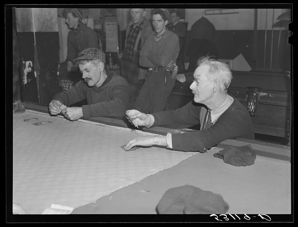 Proprietor of pool room and one of townspeople playing cards on a winter morning. Woodstock, Vermont. Sourced from the…