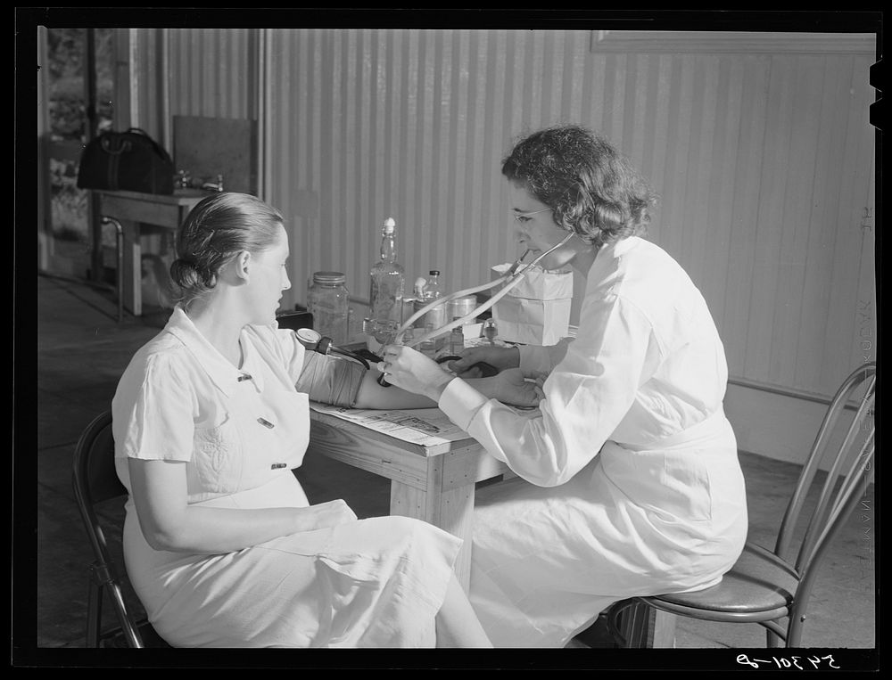 [Untitled photo, possibly related to: The project nurse takes a member's blood pressure during the prenatal clinic.…