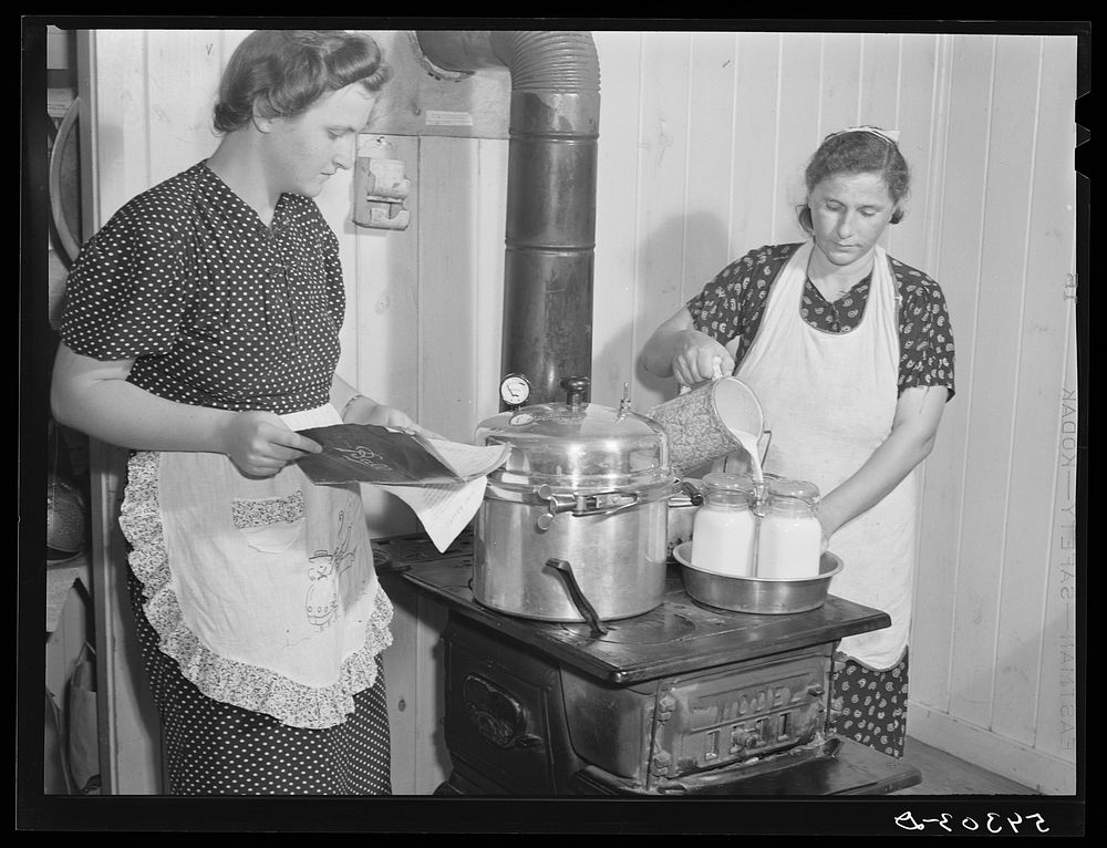 Canning milk with pressure cooker in project family's home. Terrebonne Project, Schriever, Louisiana. Sourced from the…