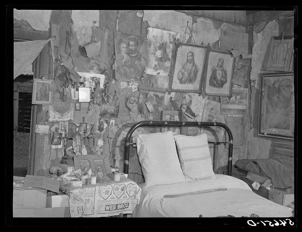 Melrose, Natchitoches Parish, Louisiana. Bedroom with religious pictures, etc. on mud walls of old hut built and still…