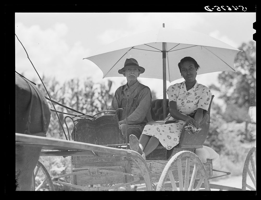 Melrose, Natchitoches Parish, Louisiana. Mulatto and his daughter going to town for groceries and supplies in cotton…