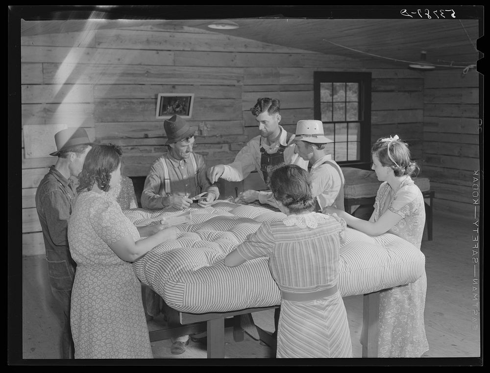 Farmers and wives tufting mattress in making-unit. Community service center, Faulkner County, Centerville, Arkansas (see…
