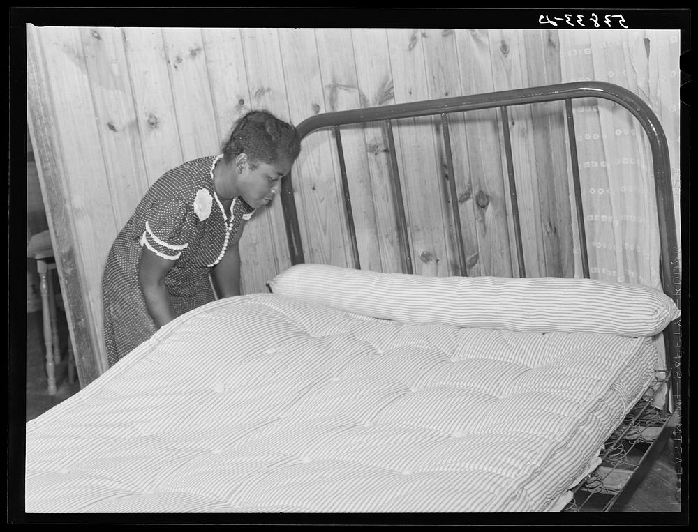 Sidney McLain adjusting the new mattress she made on the bed in her home at La Delta Project. Thomastown, Louisiana. Sourced…