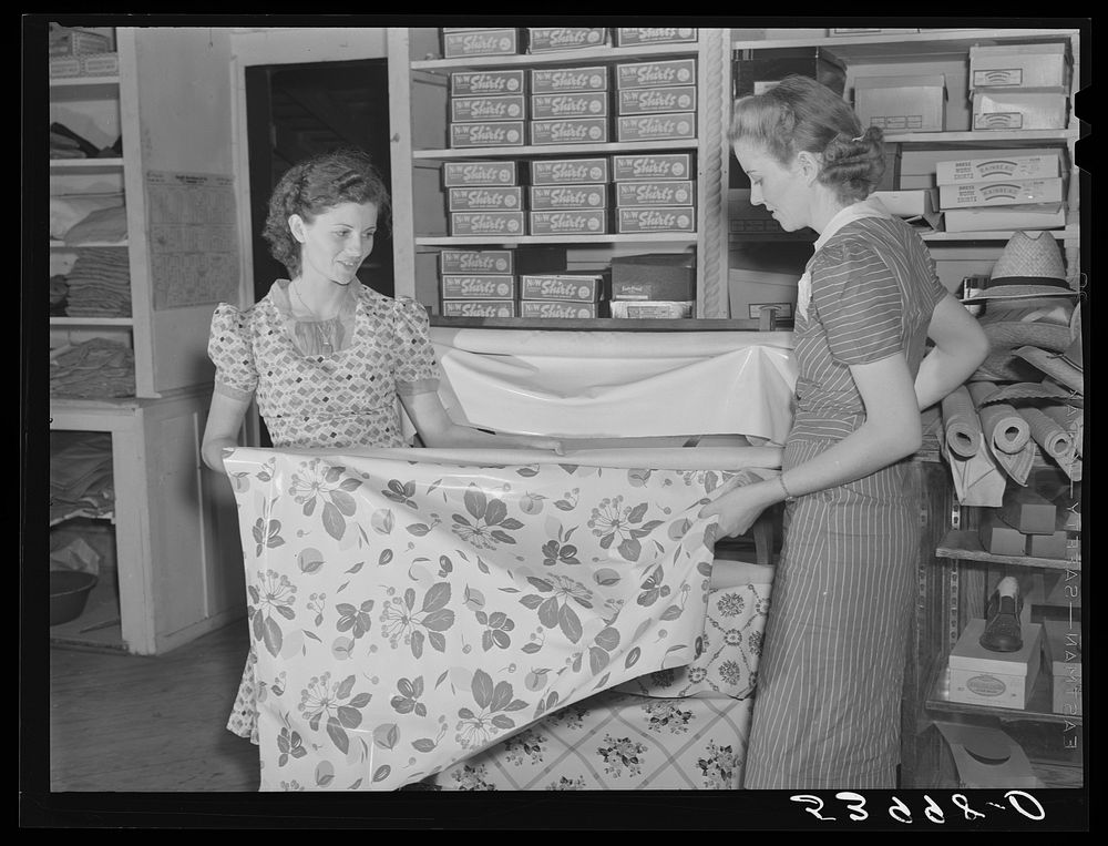 Buying linoleum for her home in project cooperative store. Transylvania Project, Louisiana. Sourced from the Library of…