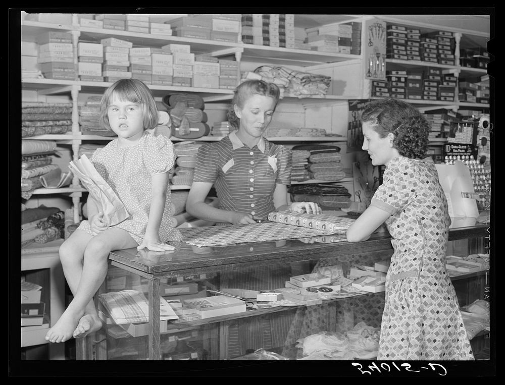 Buying dress goods in project cooperative store. Transylvania Project, Louisiana. Sourced from the Library of Congress.