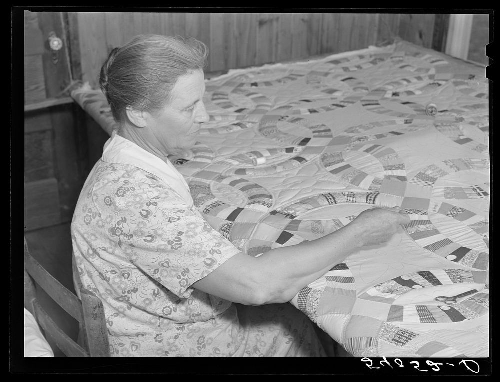 Mrs. Clarence N. Pace's mother-in-law quilting in their home. Transylvania Project, Louisiana. Sourced from the Library of…