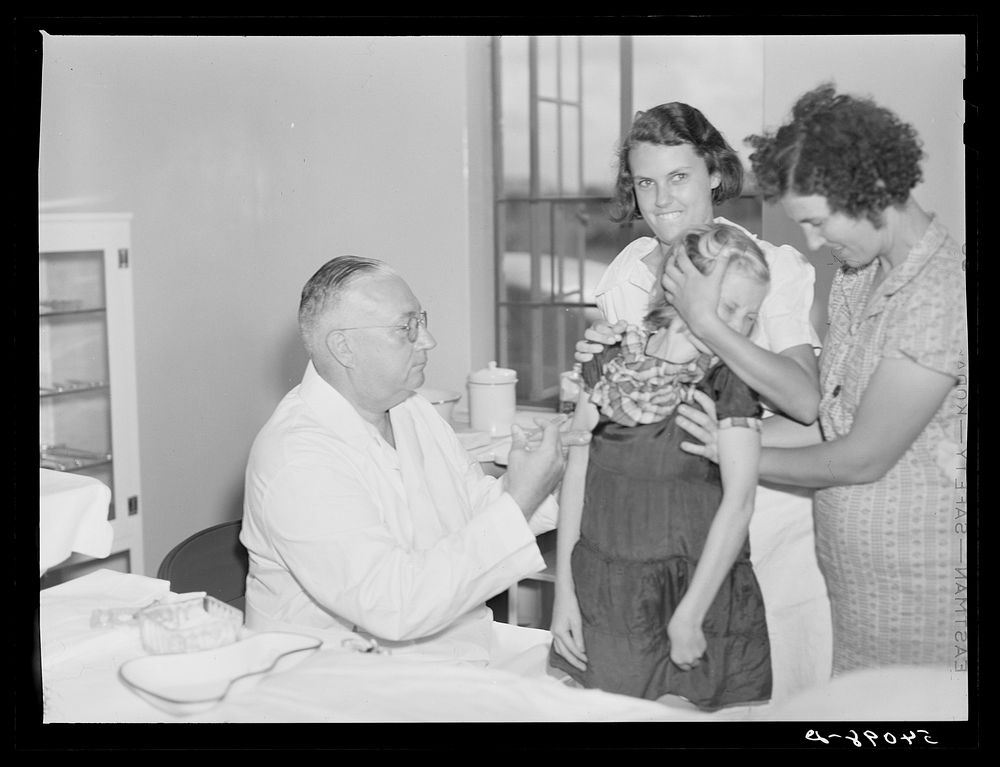 [Untitled photo, possibly related to: Dr. William J. Buck giving typhoid innoculation to child and mother, with Nurse Smock…