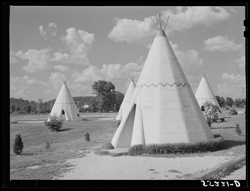 [Untitled photo, possibly related to: Cabins imitating the Indian teepee for tourists along highway south of Bardstown…