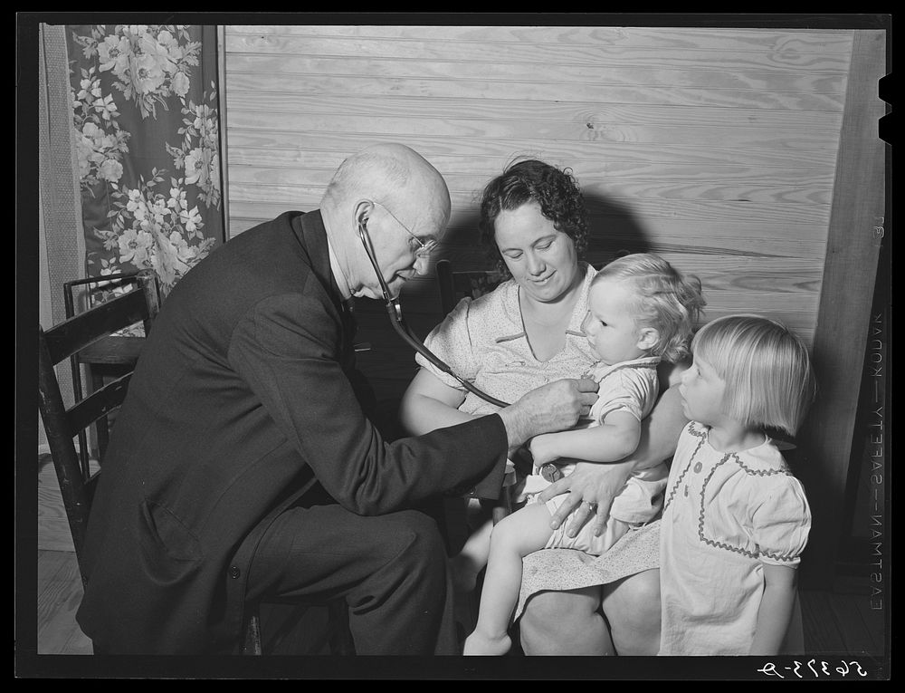 Dr. S.A. Malloy examining Mrs. William H. Willis and her family. Mr. Willis is a FSA (Farm Security Administration)…