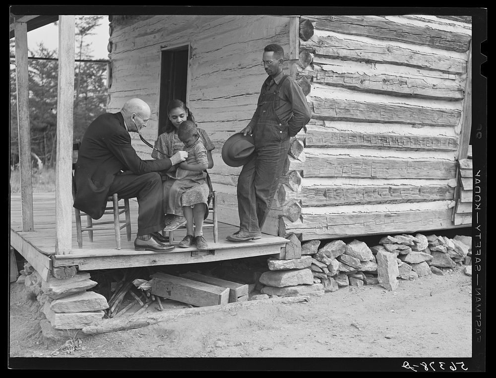 [Untitled photo, possibly related to: Dr. S.A. Malloy examining Louis Graves and his family on their front porch. They are…