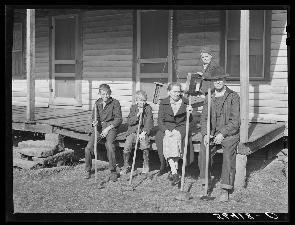 Dutton ("Dut") Calleb and his family with their homemade hoes on the porch of their home. Southern Appalachian Project near…