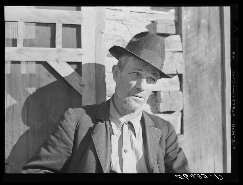 [Untitled photo, possibly related to: Noah Garland sitting on the steps of his son's home. Southern Appalachian Project near…