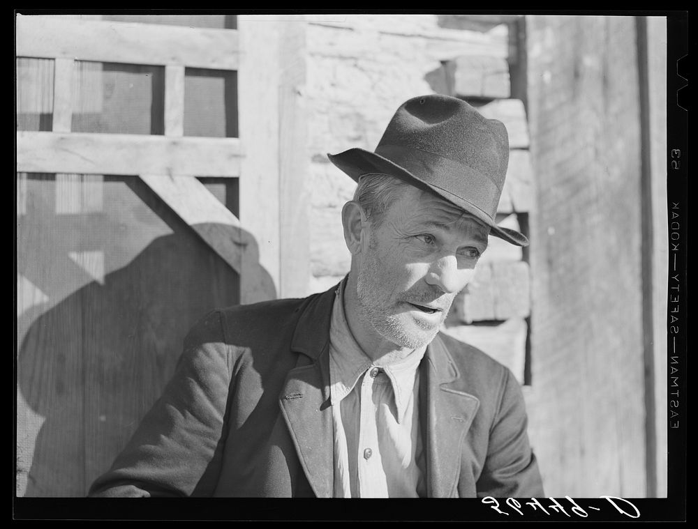 Noah Garland sitting on the steps of his son's home. Southern Appalachian Project near Barbourville, Knox County, Kentucky.…