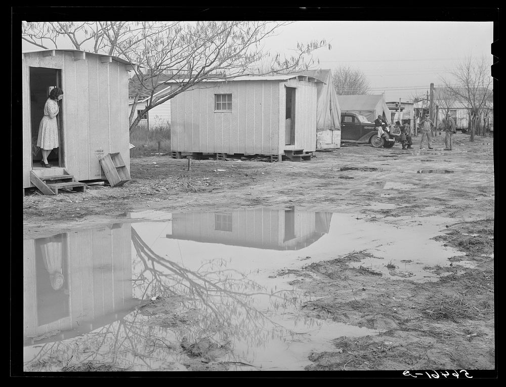 Columbus, Georgia. Metal shelters and tents of Army men and construction workers in backyard of W.T. Mullis, who owns home…