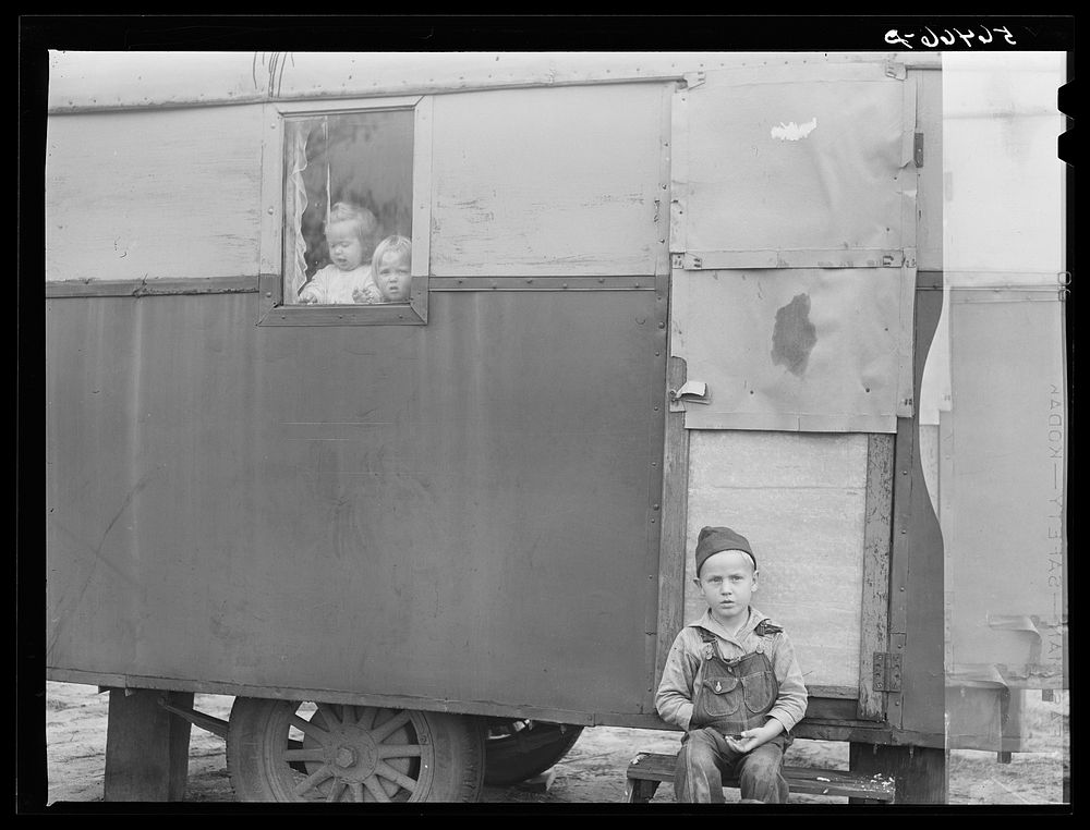 Children looking out of trailer window. Trailer where C.E. Childre and family live in highway about three miles from Fort…