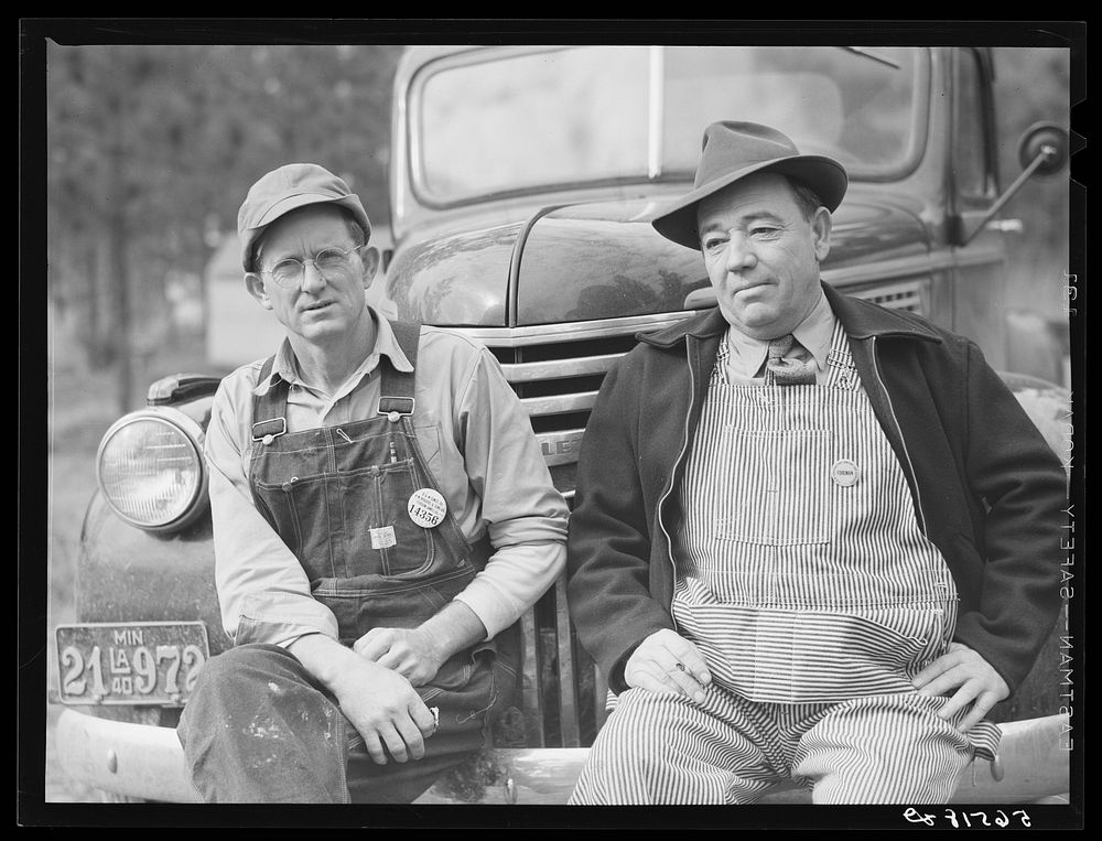 Construction workers from Monroe, Louisiana. Sitting on car in front of their shacks before leaving for evening shift. Camp…