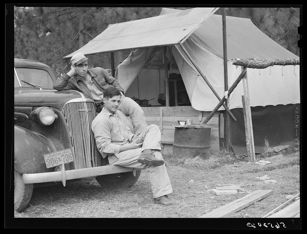 [Untitled photo, possibly related to: Construction workers from Monroe, Louisiana. Sitting on car in front of their shacks…