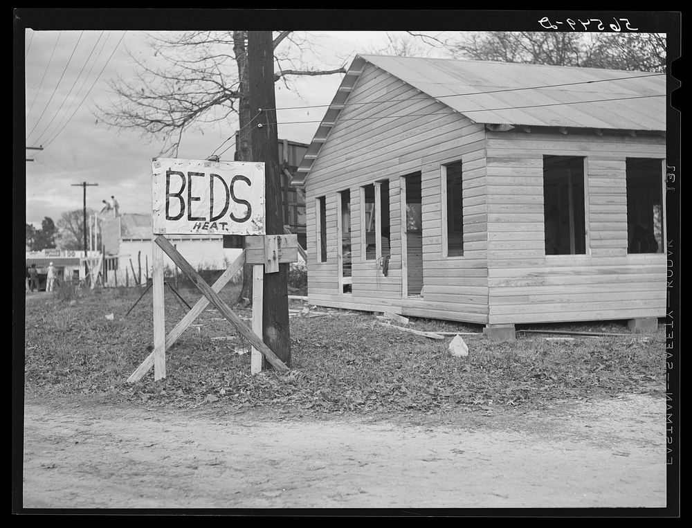 Sign on highway No. 165 near Fort Beauregard (beds and heat). New construction in background. Alexandria, Louisiana. Sourced…