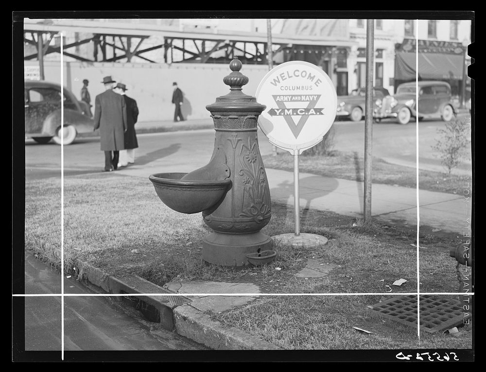 Water trough and Y.M.C.A. (Young Mens Christian Association) welcome sign in square in center of town.  Columbus, Georgia.…