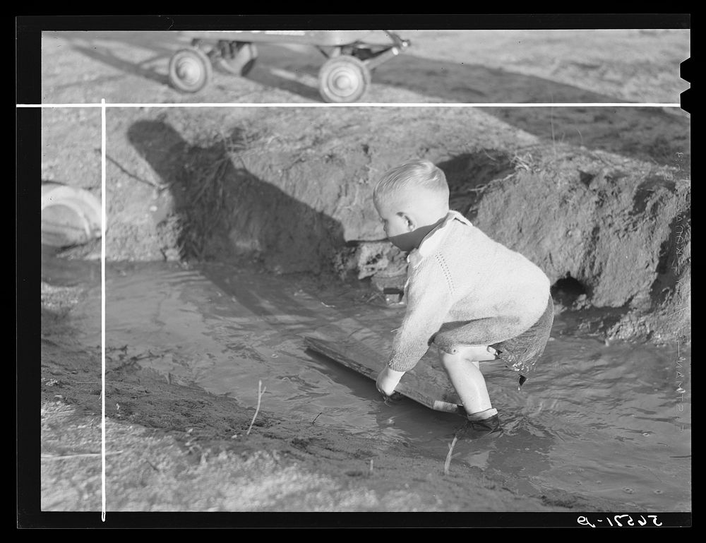 Child playing in front of his home on Milstead Avenue about five miles outside of Columbus, Georgia. Near Fort Benning. His…
