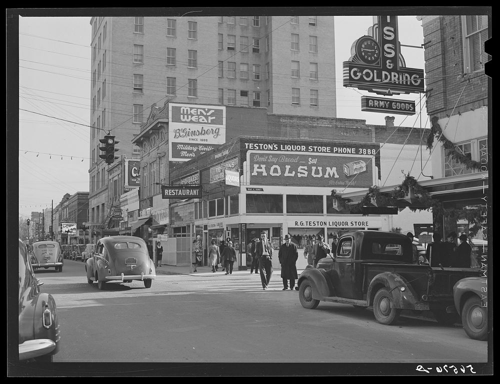 [Untitled photo, possibly related to: Corner building in center of Alexandria showing signs and advertising Army and…