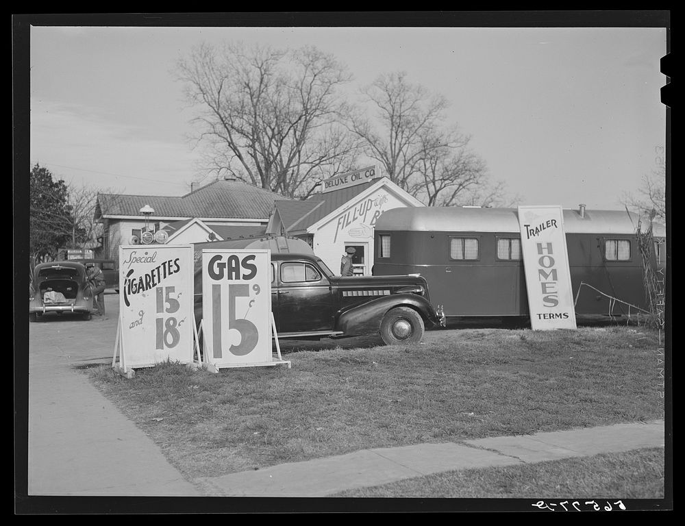 Signboard advertising trailer homes by gas station along main highway from Alexandria, Louisiana to Fort Beauregard. Sourced…