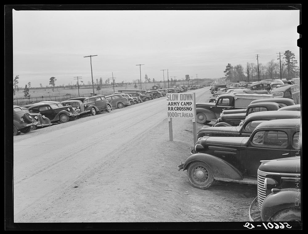 [Untitled photo, possibly related to: Construction workers' cars parked along highway by Camp Claiborne near Alexandria…