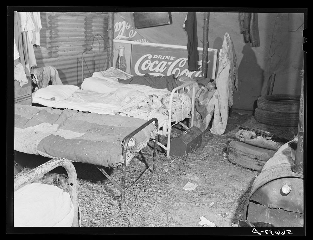 [Untitled photo, possibly related to: Shack built of tin, lived in by ten construction workers from Texas now working on…