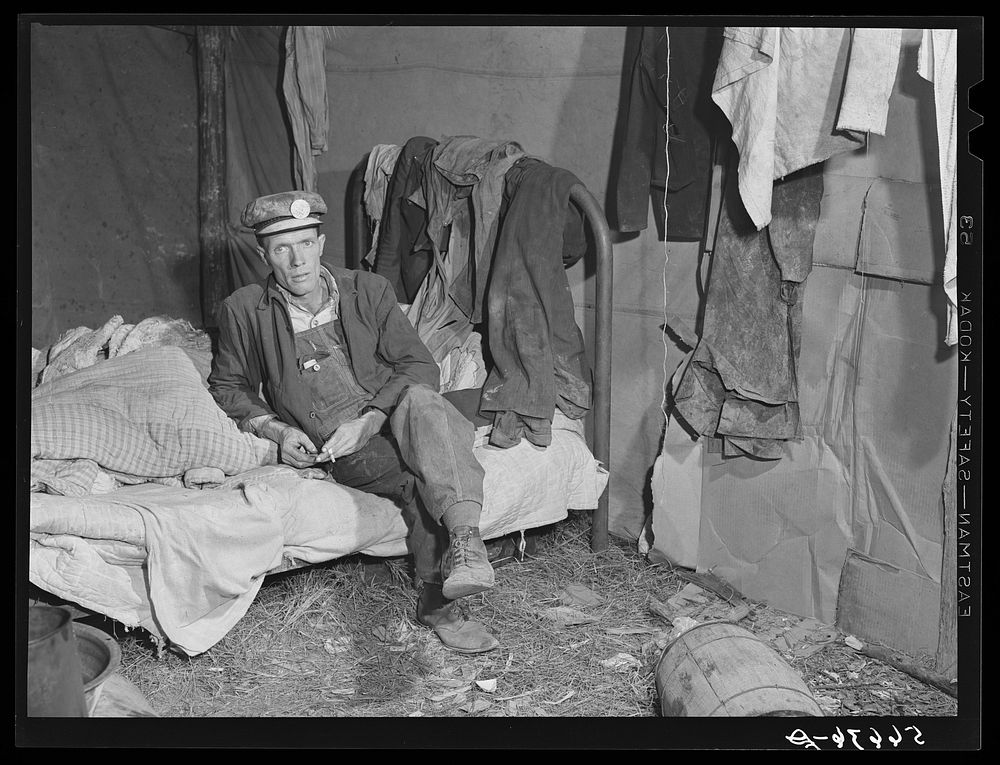 Interior of shack described in other pictures. Mr. W.R. Carpenter of Beaumont, Texas also a truck driver, seated on bed. Men…