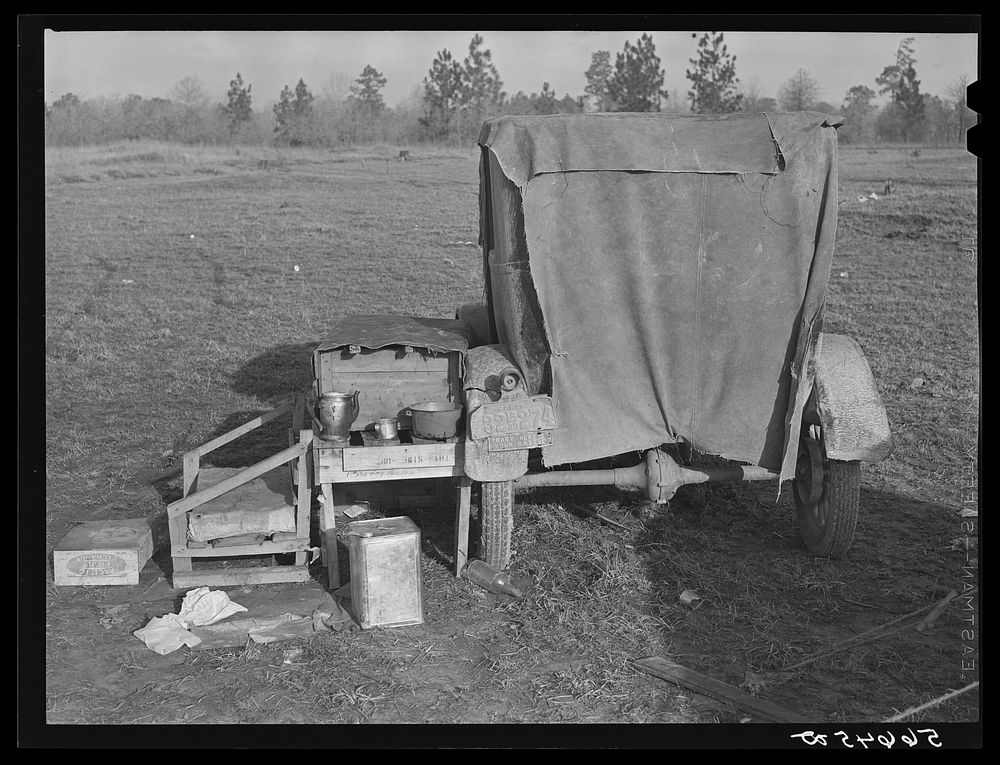 [Untitled photo, possibly related to: Tent and farm truck used for sleeping and general housing by construction workers off…