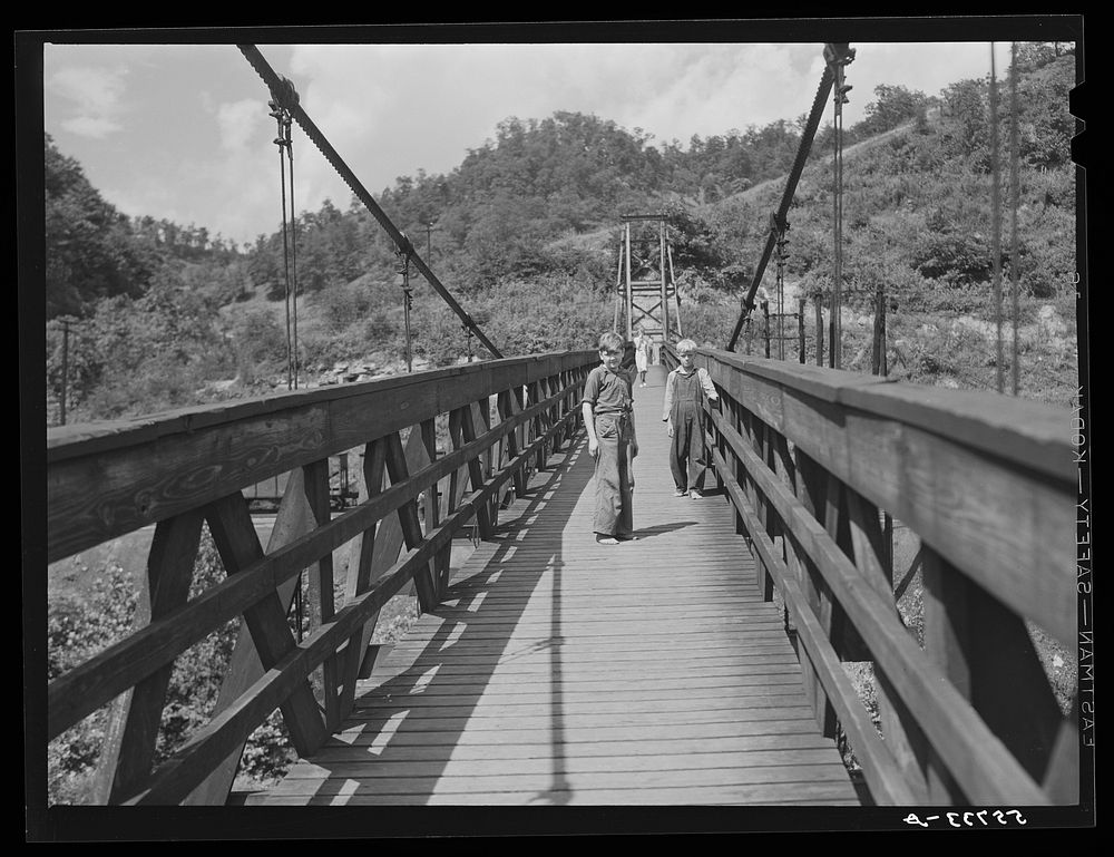 Miners' children crossing swinging bridge from their homes into town. Hazard, Kentucky. Sourced from the Library of Congress.