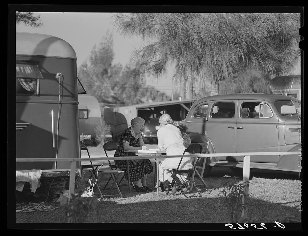 Guests of trailer park playing Chinese checkers outside their trailer home. Sarasota trailer park, Sarasota, Flordia.…