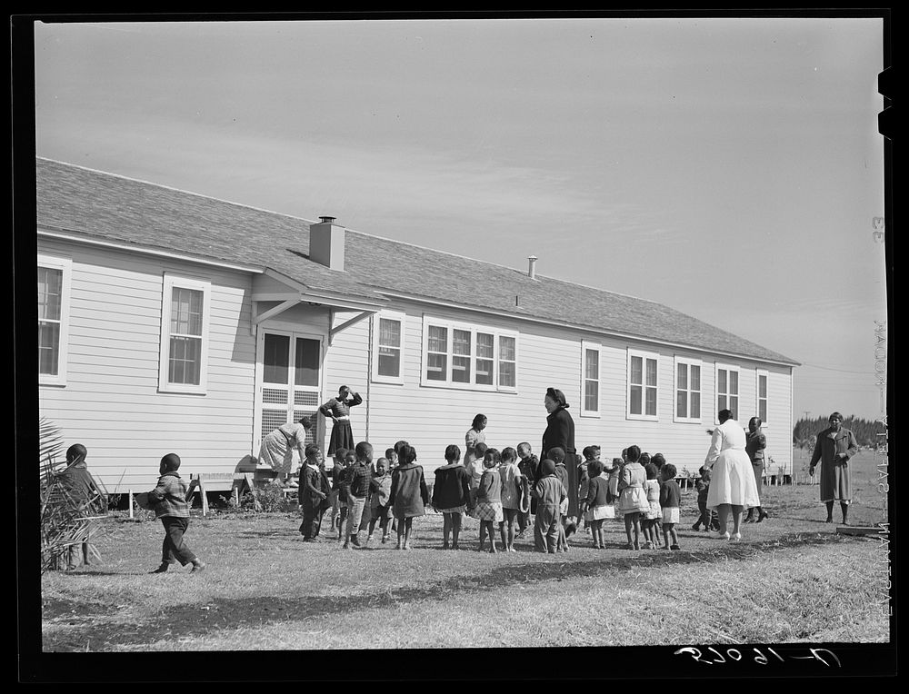  childen playing outside of nursey at Okeechobee migratory labor camps built by FSA (Farm Security Administration). Belle…