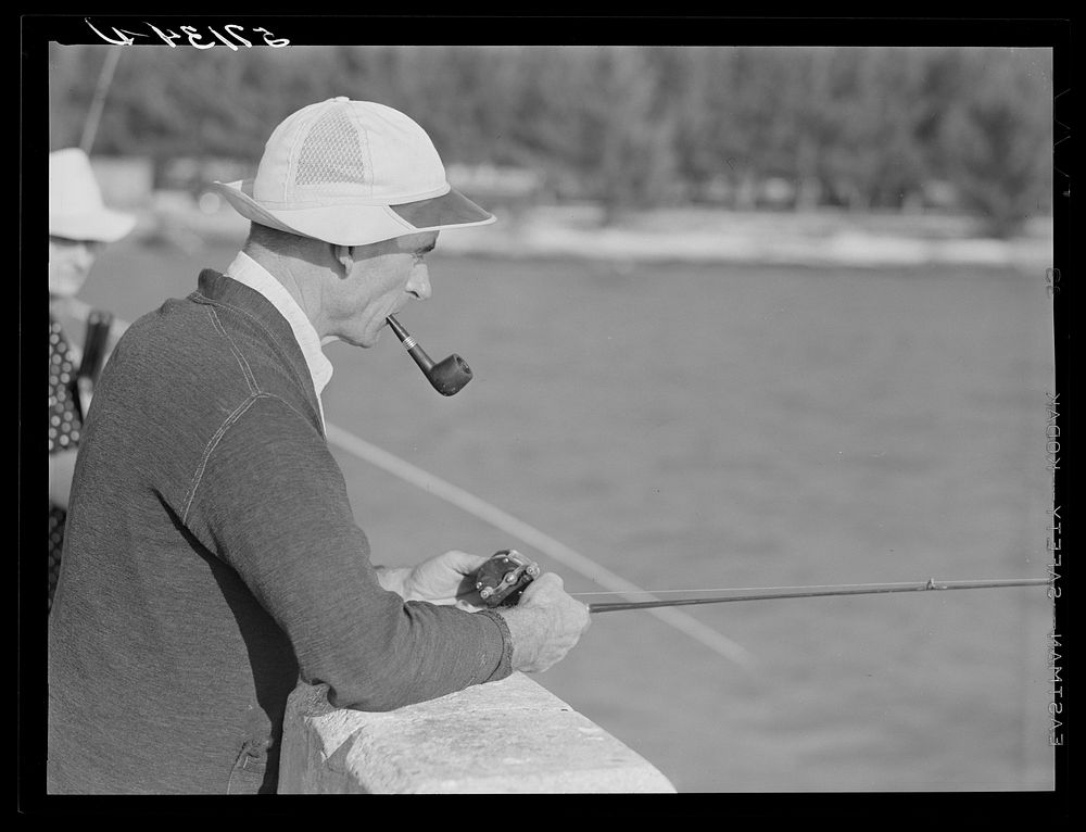 Guest of Sarasota trailer park, Sarasota, Florida, fishing from bridge. Sourced from the Library of Congress.
