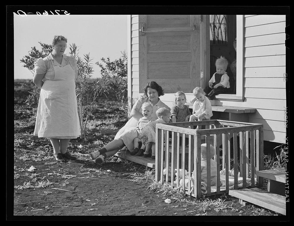 Agricultural day laborer's family on steps of shelter in Osceola migratory labor camp. Belle Glade, Florida. Sourced from…
