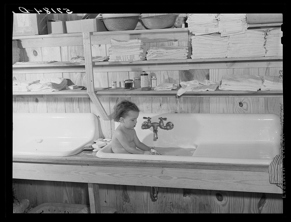 Agricultural worker's child taking a bath in the twenty-four hour a day nursery at Osceola migratory labor camp. Belle…