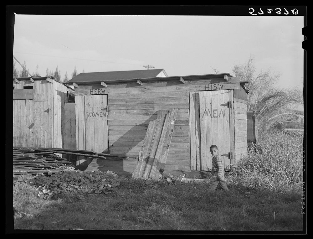 Sanitary facilities for agricultural workers living at the Pahokee "Hotel." Pahokee, Florida. Sourced from the Library of…