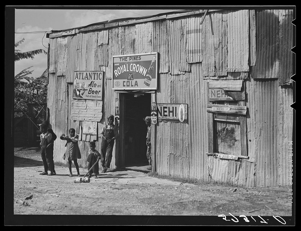 Living quarters, store, and "juke joint" for migratory laborers near Canal Point, Florida. Sourced from the Library of…
