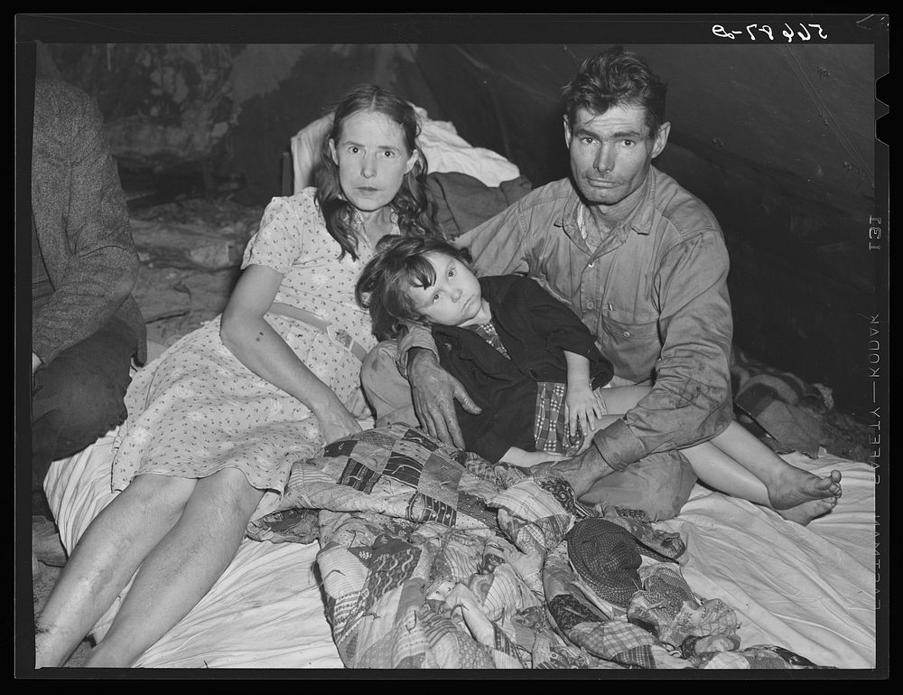 Construction worker with wife and neighbor's child in tent home near Alexandria, Louisiana. Ten men, two women, and two…