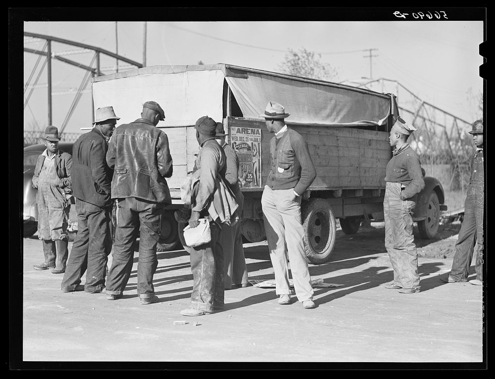  construction workers waiting by truck to go to work on Camp Livingston jobs. Alexandria, Louisiana. Sourced from the…