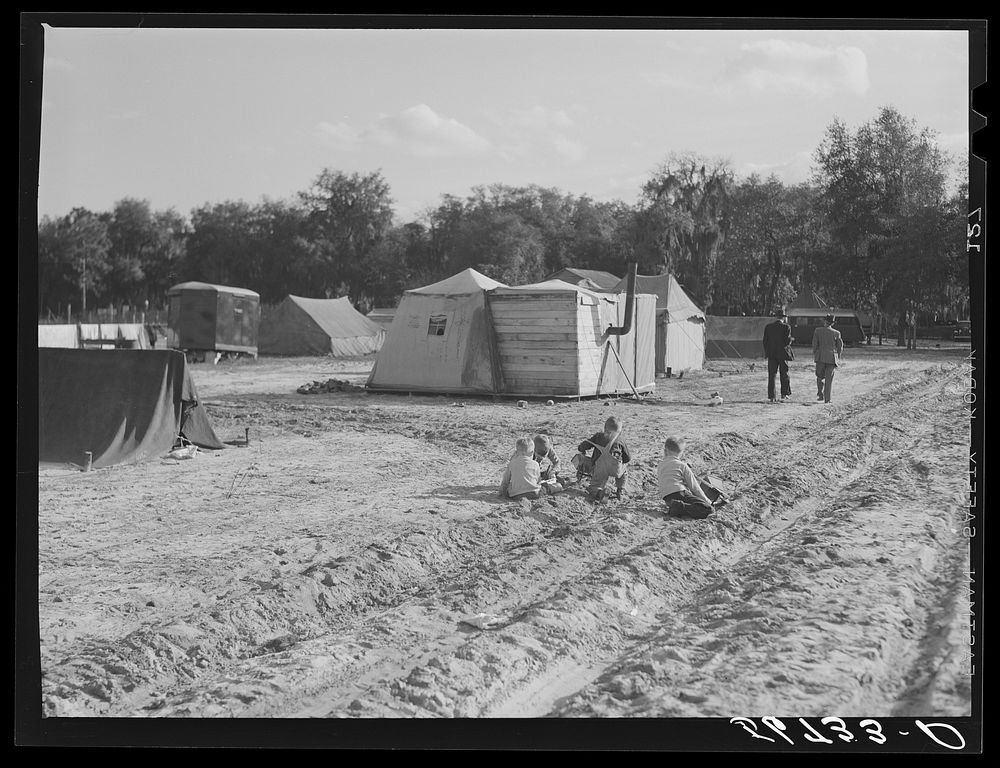 [Untitled photo, possibly related to: Construction workers' children playing in front of their shacks and tents in camp near…